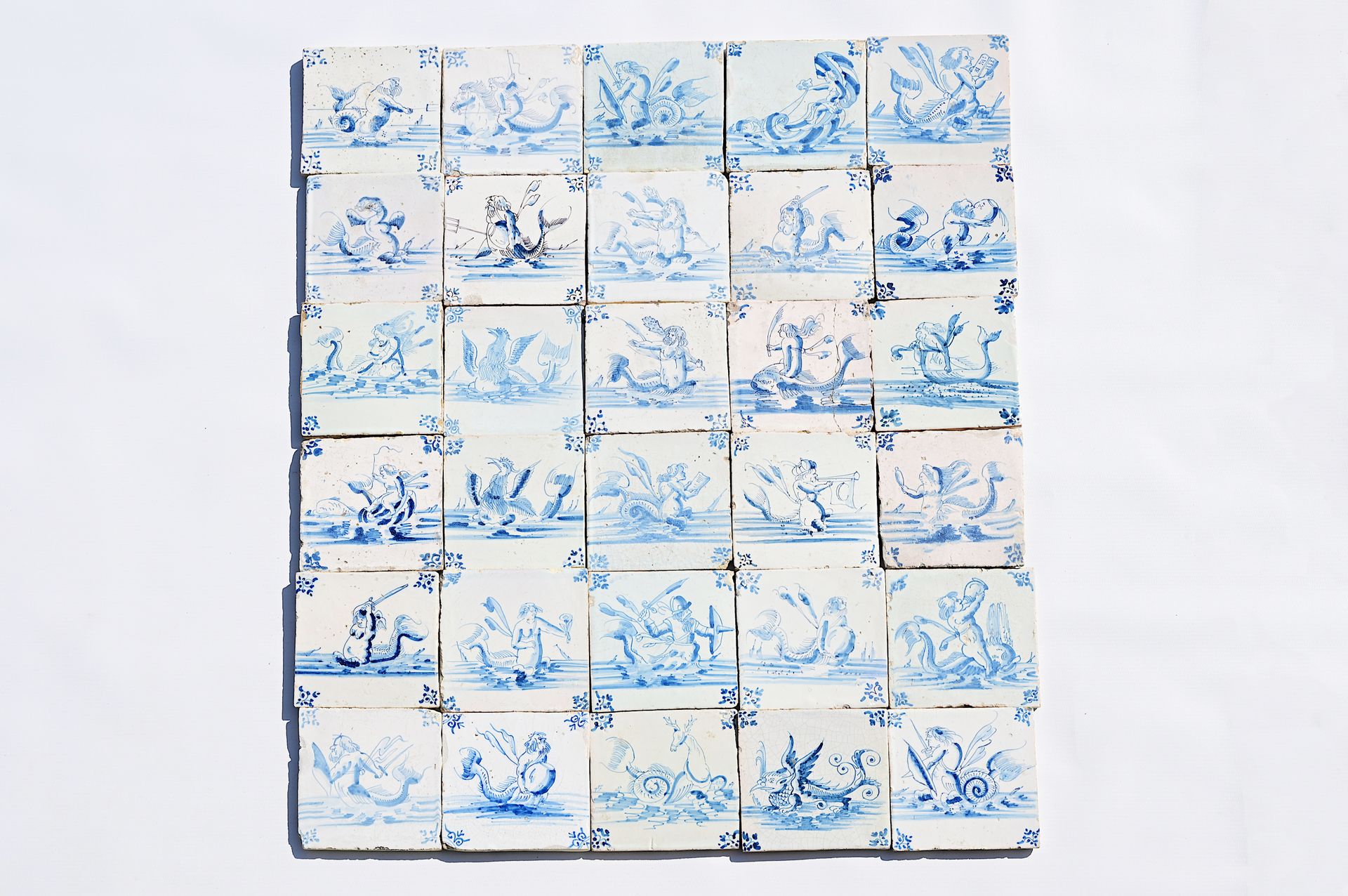 Thirty Dutch Delft blue and white 'sea monster' tiles, 17th C. Treinta azulejos &hellip;