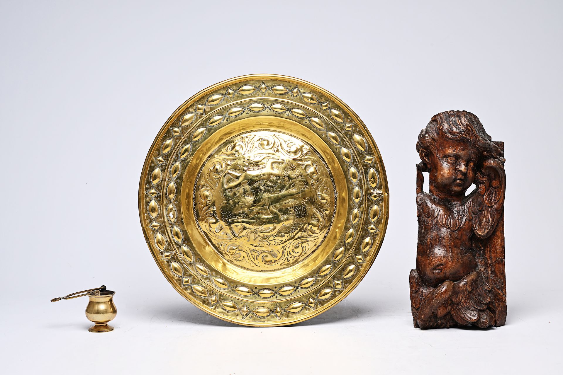 A German brass 'Adam and Eve' alms dish, a holy water font and a carved wood put&hellip;