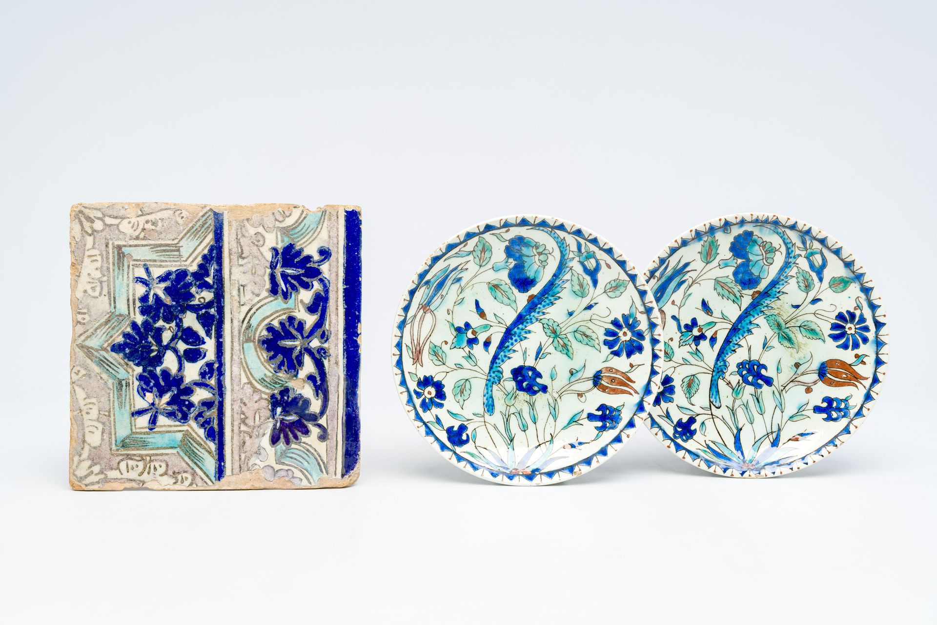 A pair of polychrome Kutahya Iznik style plates and a Qajar tile, 19th C. A pair&hellip;