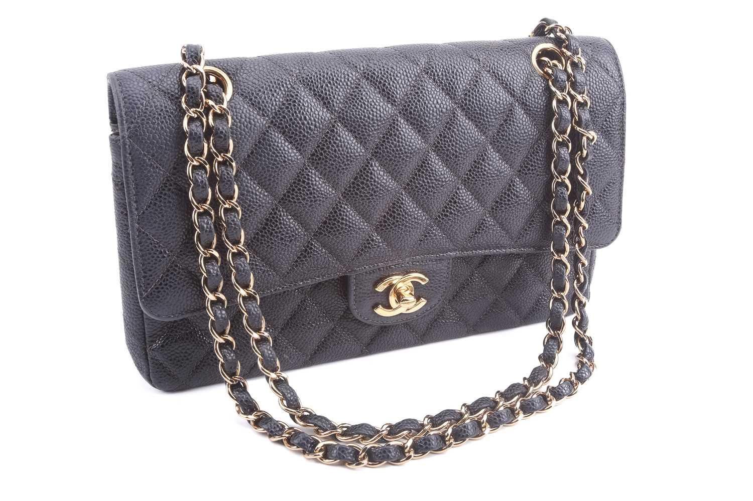 Chanel - a medium classic double flap bag in black diamo…