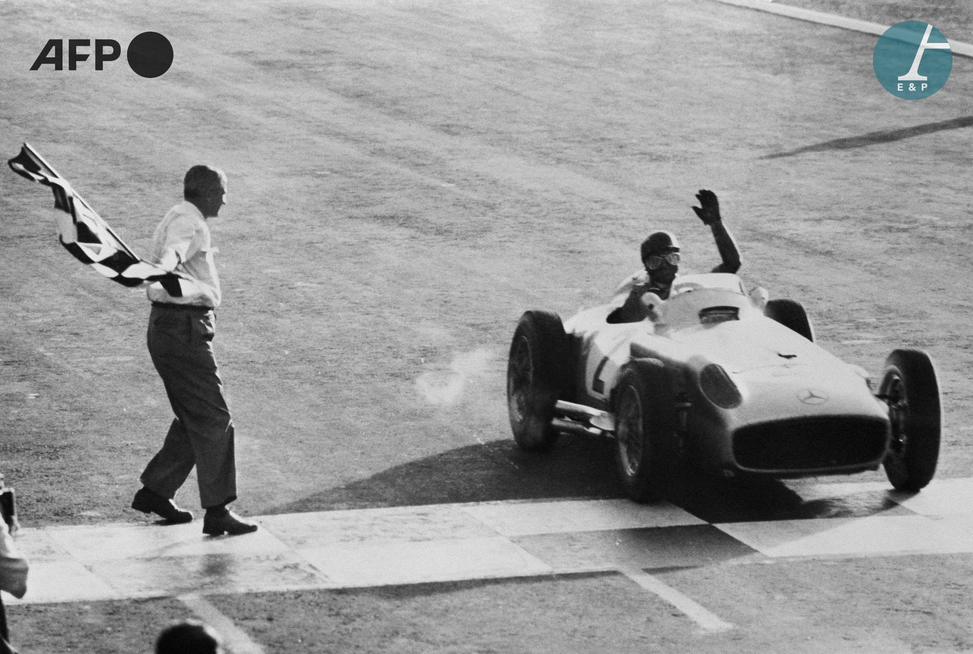 Null 
AFP

阿根廷车手胡安-曼努埃尔-范吉奥在他的梅赛德斯赛车的方向盘上，在冲过一级方程式全国大奖赛的终点线时挥手致意。1955年1月16日，布宜诺斯&hellip;