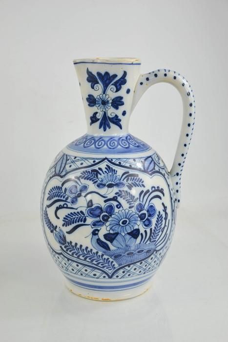 Null An early 20th century delft blue and white jug of ovid form, embossed with &hellip;