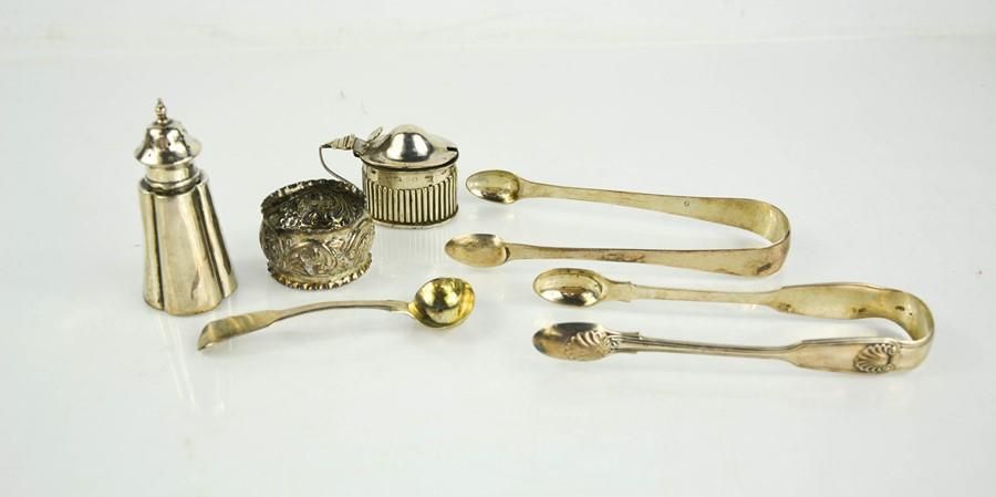 Null A group of silver to include sugar tongs, sauce spoon, napkin ring, pepper &hellip;