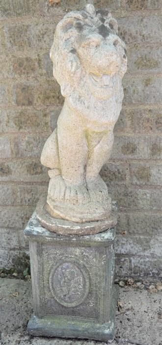 Null A reconstituted stone lion garden ornament and plinth 81cms