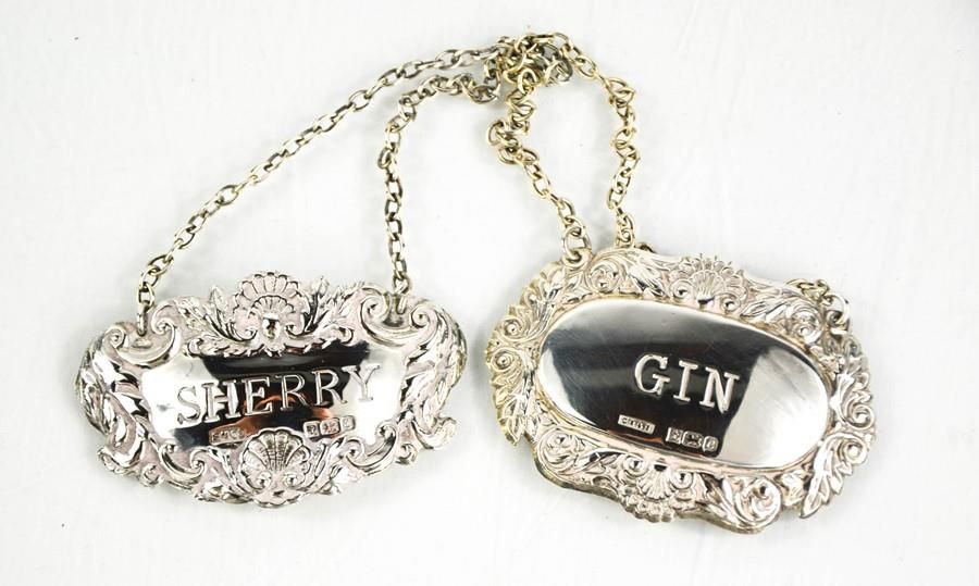 Null Two silver bottle tags: Gin and Sherry, both embossed with decoration, 0.73&hellip;