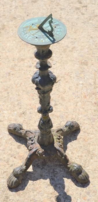 Null A bronze sundial on a cast iron base, 75cms tall
