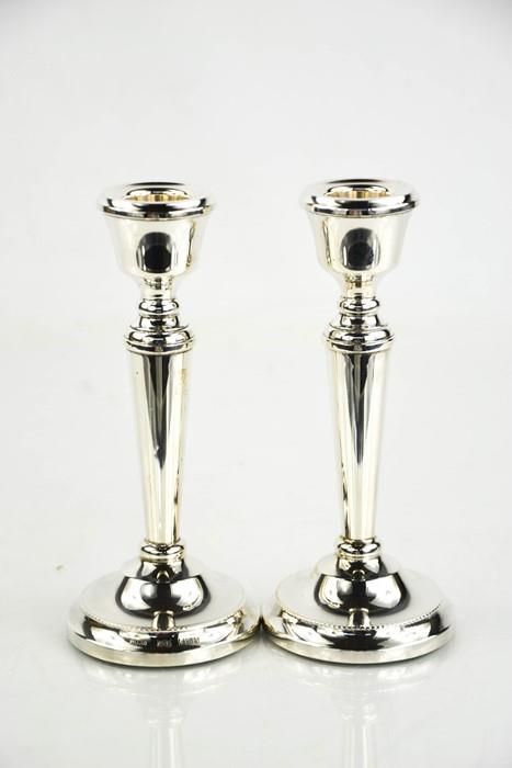 Null A pair of silver candlesticks, Birmingham 1979, with weighted bases.