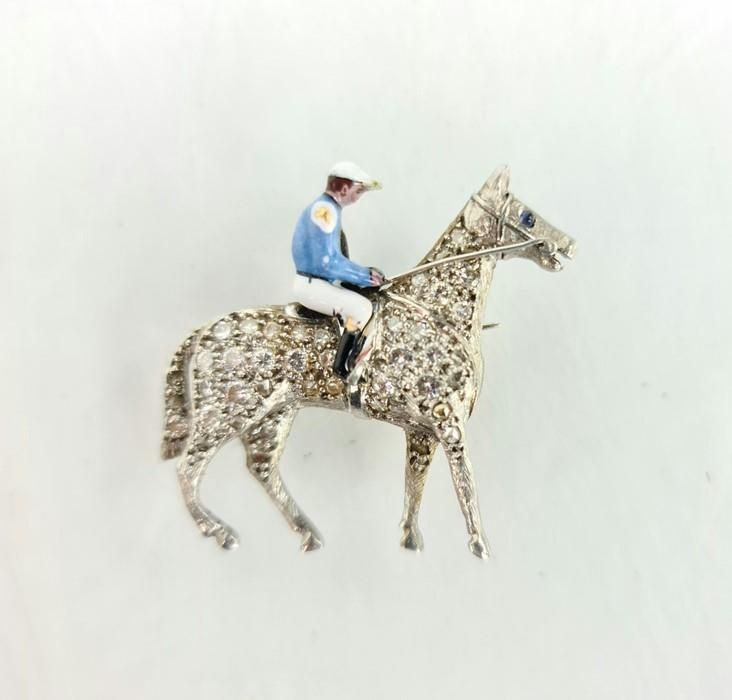 Null A fine platinum, diamond and enamel brooch in the form of horse and jockey,&hellip;