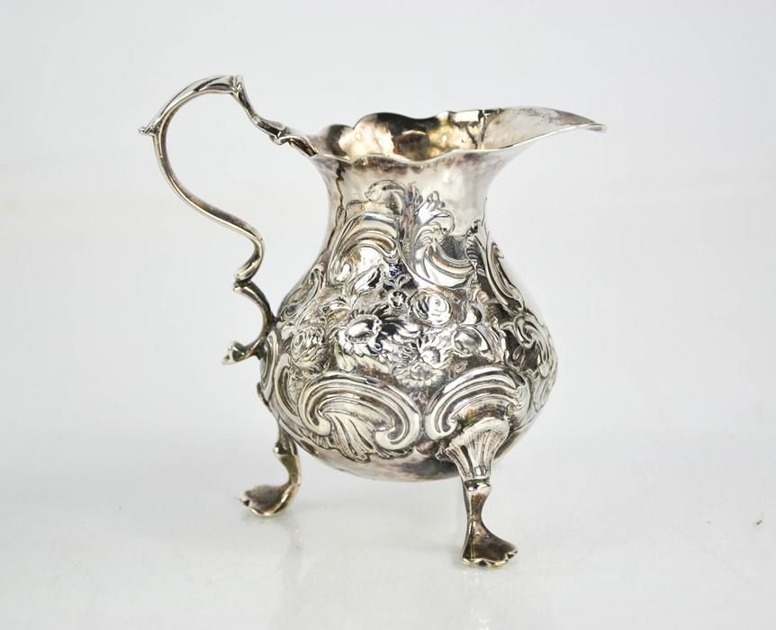 Null A silver jug embossed with scrollwork, indistinct London hallmarks, initial&hellip;