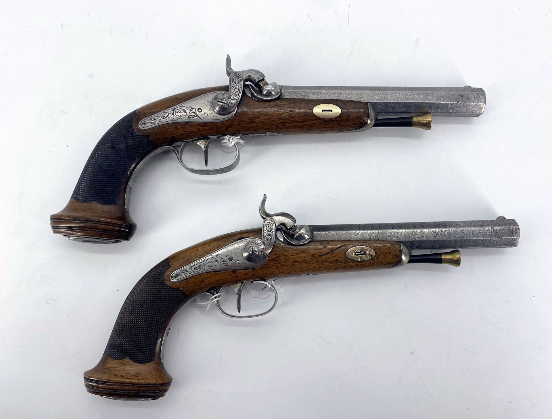 Null Pair of percussion pistols. Slightly engraved back plate. Short barrels. Cr&hellip;