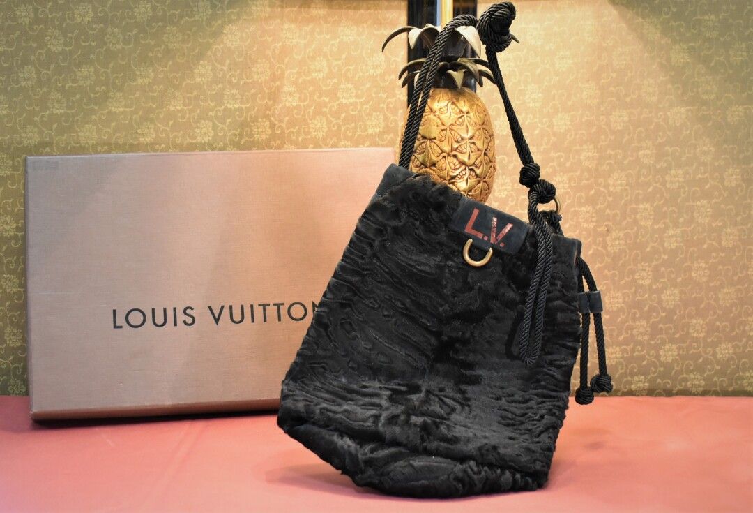 Louis VUITTON. Bucket bag in astrakhan with an LV monogr…