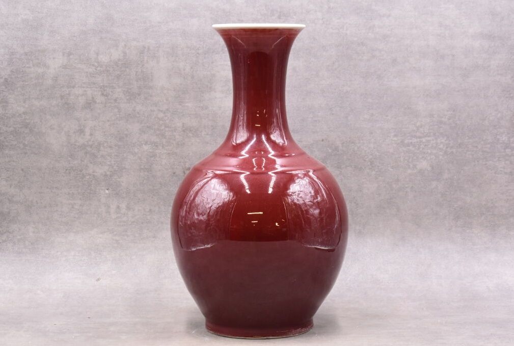 CHINE. CHINA. Vase with long neck in oxblood porcelain. Marked under the base. H&hellip;
