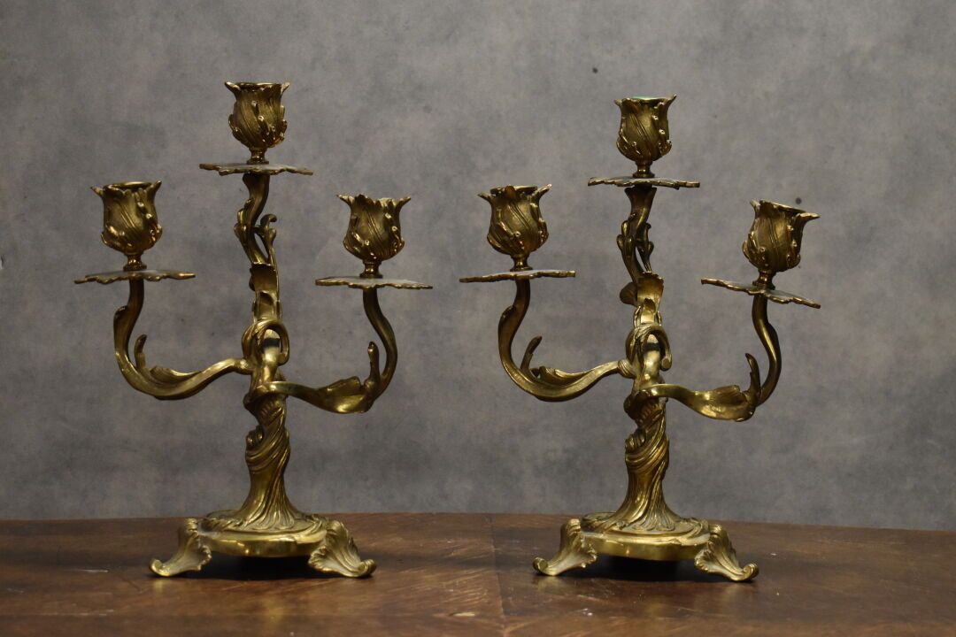 Null Pair of candlesticks in chased and gilded bronze with three lights decorate&hellip;