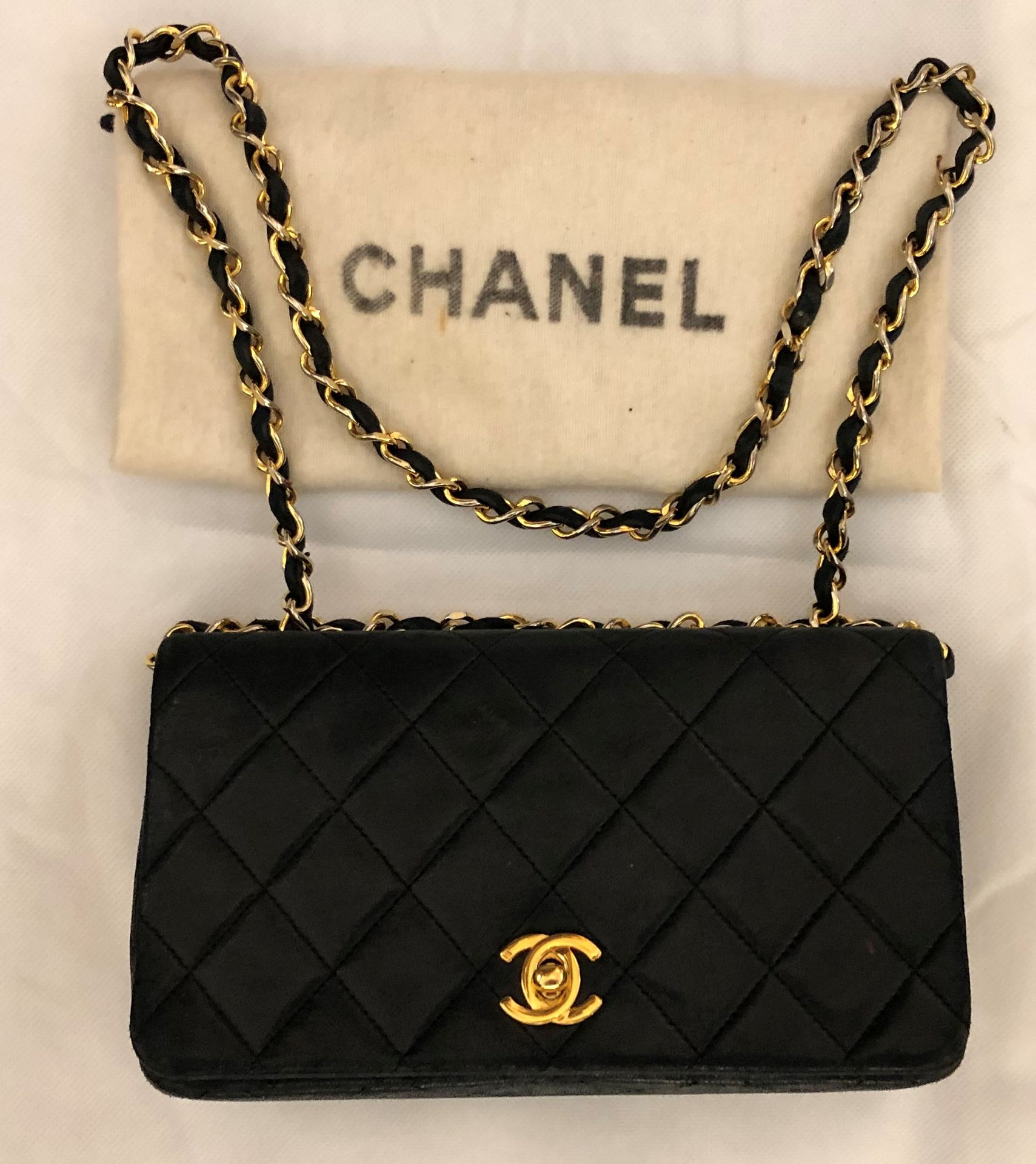CHANEL. Mini handbag in navy blue quilted lambskin leath…