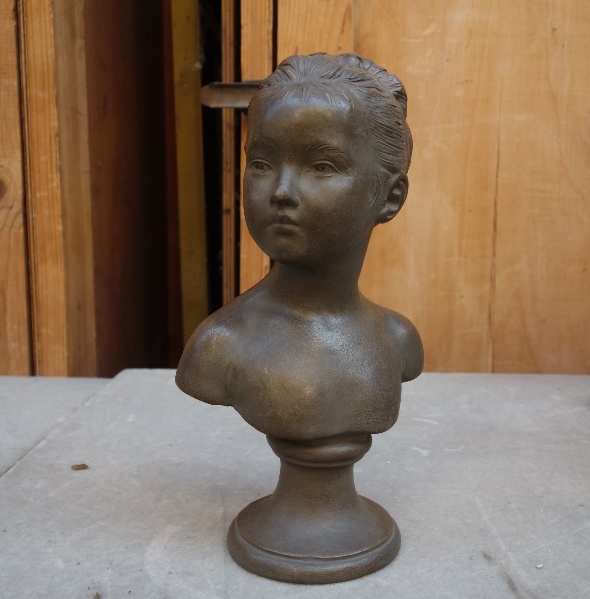 Houdon, d'après 
Petit buste de fillette
Plâtre patiné.
