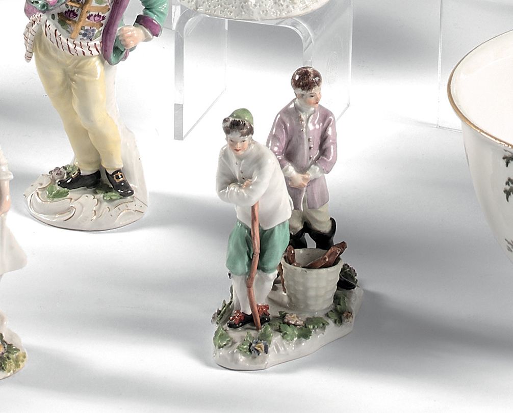 MEISSEN 两个樵夫的小团体，站在花的底座上，脚下拿着棍子和装满木头的篮子，有多色的装饰。
底座上有标记。
18世纪（对一些花和底座的一小部分进行了修复；一&hellip;