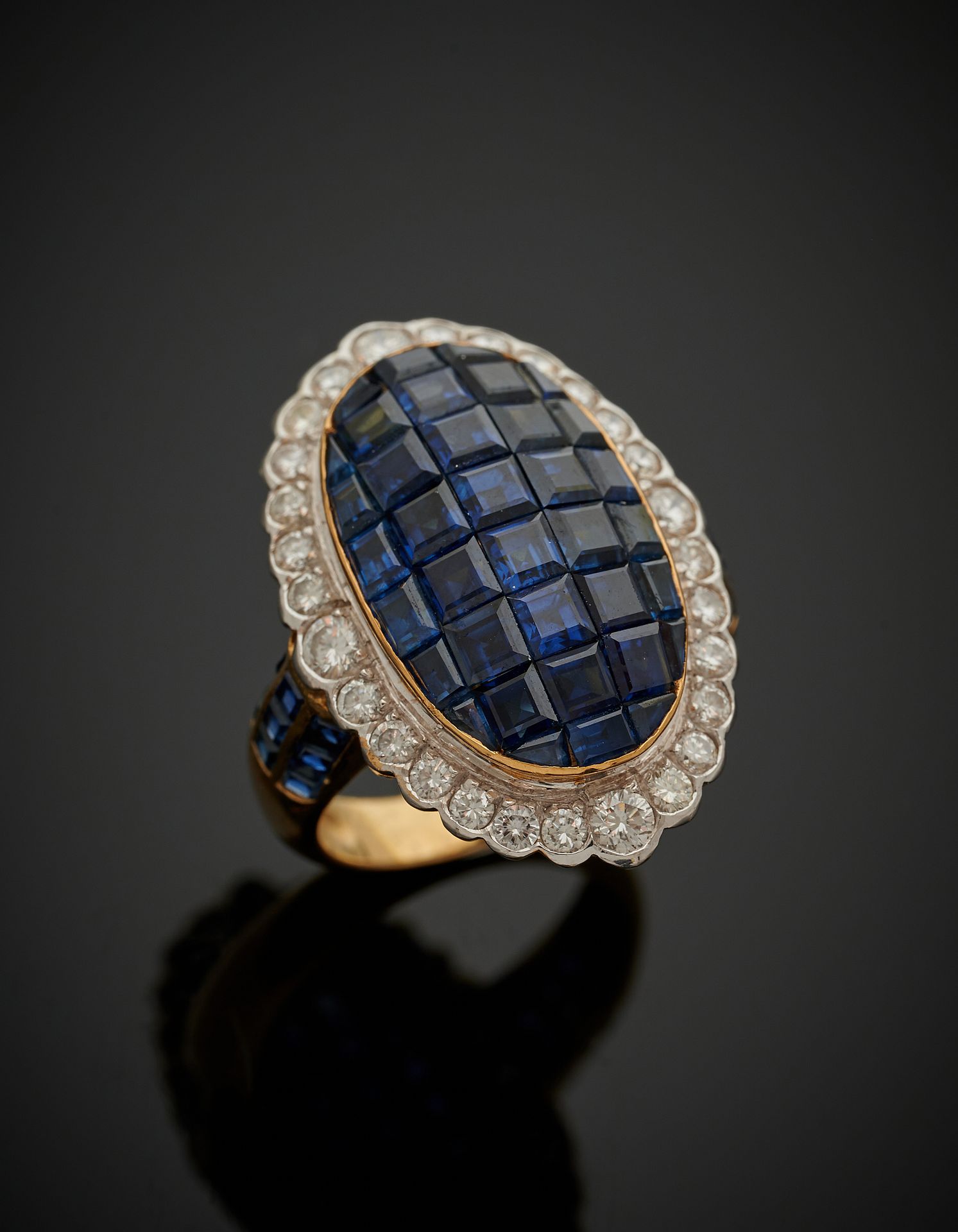 Null 一枚白金和黄金（750‰）的椭圆形戒指，以隐形镶嵌的方式镶嵌校准蓝宝石，周围是明亮式切割的钻石，肩部是三条排列的校准蓝宝石。

手指：56。毛重：10&hellip;