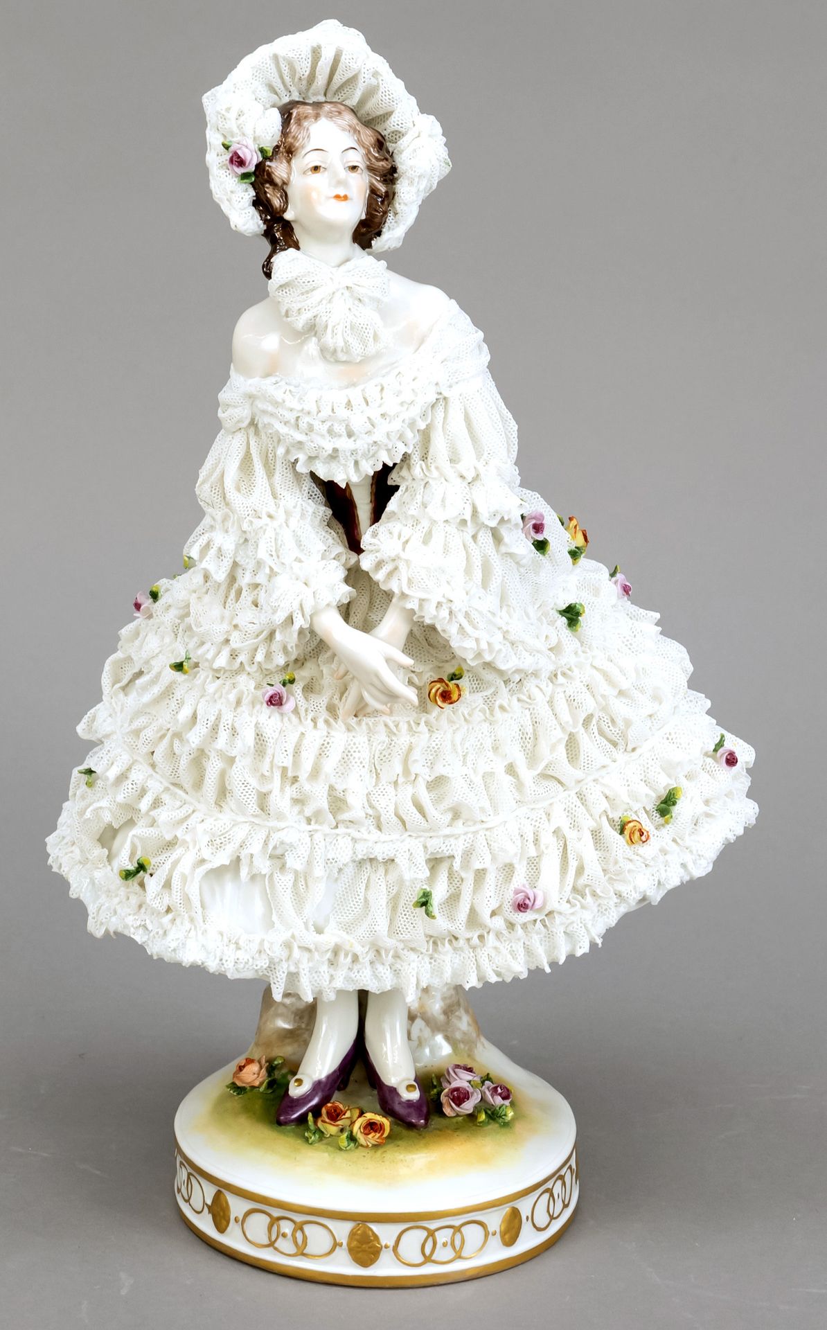 Dancer, Volkstedt, Thuringia, 20th century, ballerina in tulle dress, 2nd  choice, polychrome painted and ornamental gilding, tulle dress decorated  with plastic flowers, bumped, on round pedestal, h. 32 cm