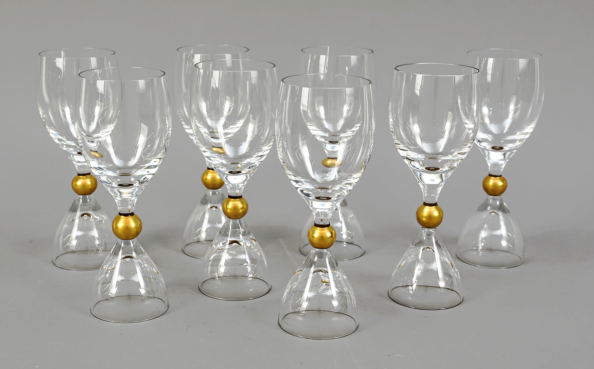 Null 八个罗森塔尔酒杯，1970/1980年代，由Björn Wiinblad设计，钟形支架，带球状模式的杯柄，椭圆形碗，透明玻璃，金色装饰，高17.5厘米