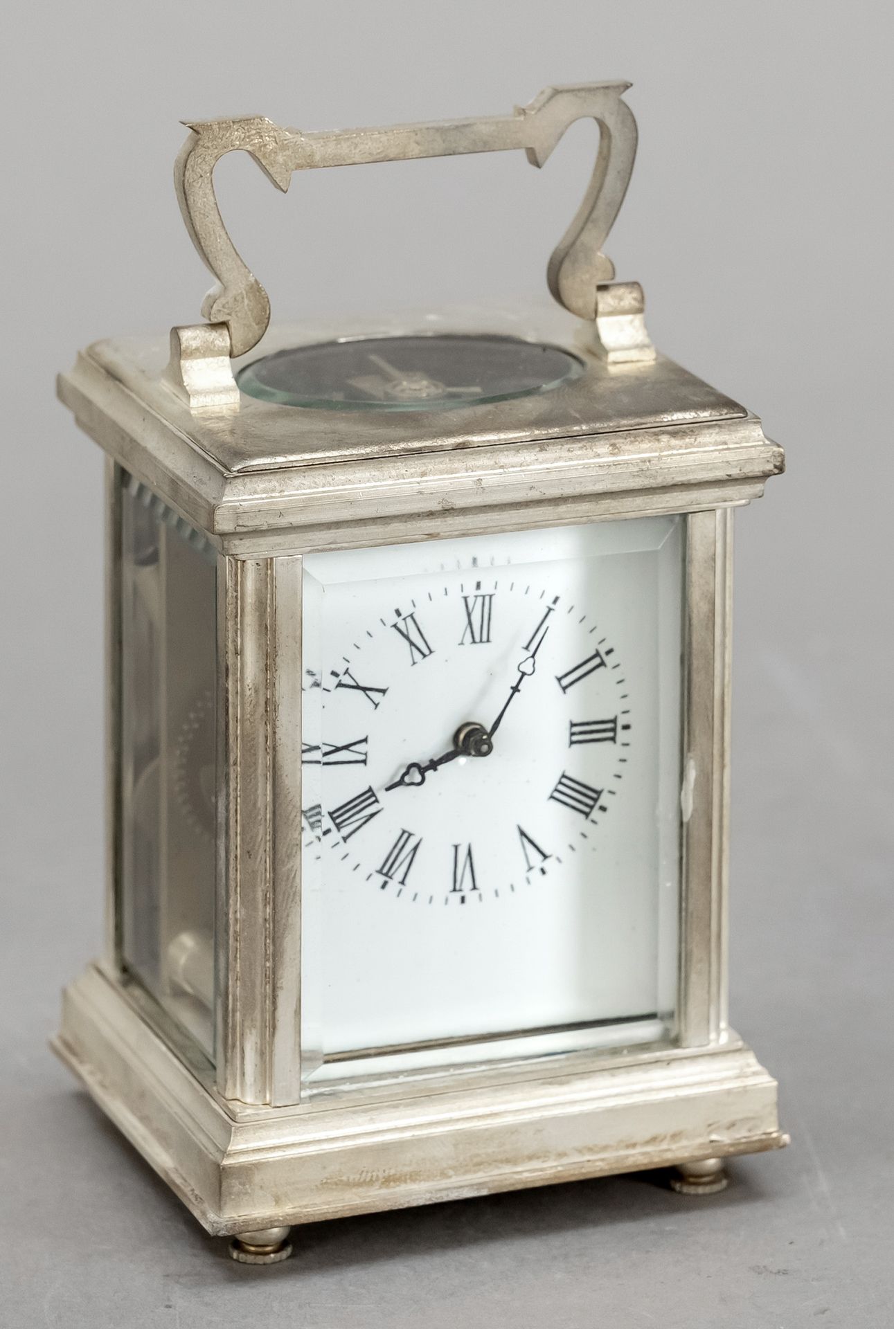 Null 旅行钟，20世纪下半叶，镀银，顶部把手，白色珐琅表盘上有罗马数字，黑色指针，四面有刻面玻璃，机芯有托盘式擒纵机构，钟表运行，高11厘米，宽6厘米，长5&hellip;