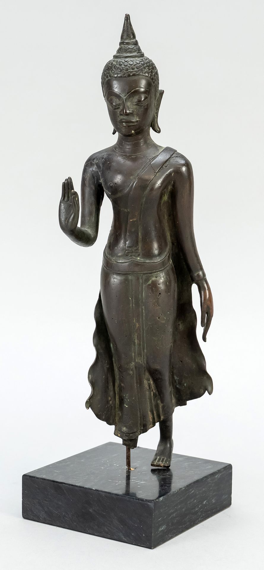 Null 站立的佛像，可能是老挝，19世纪（或更早），青铜。该雕像缺少右脚，通过一个金属销安装在一个方形的石头底座上，高33厘米。