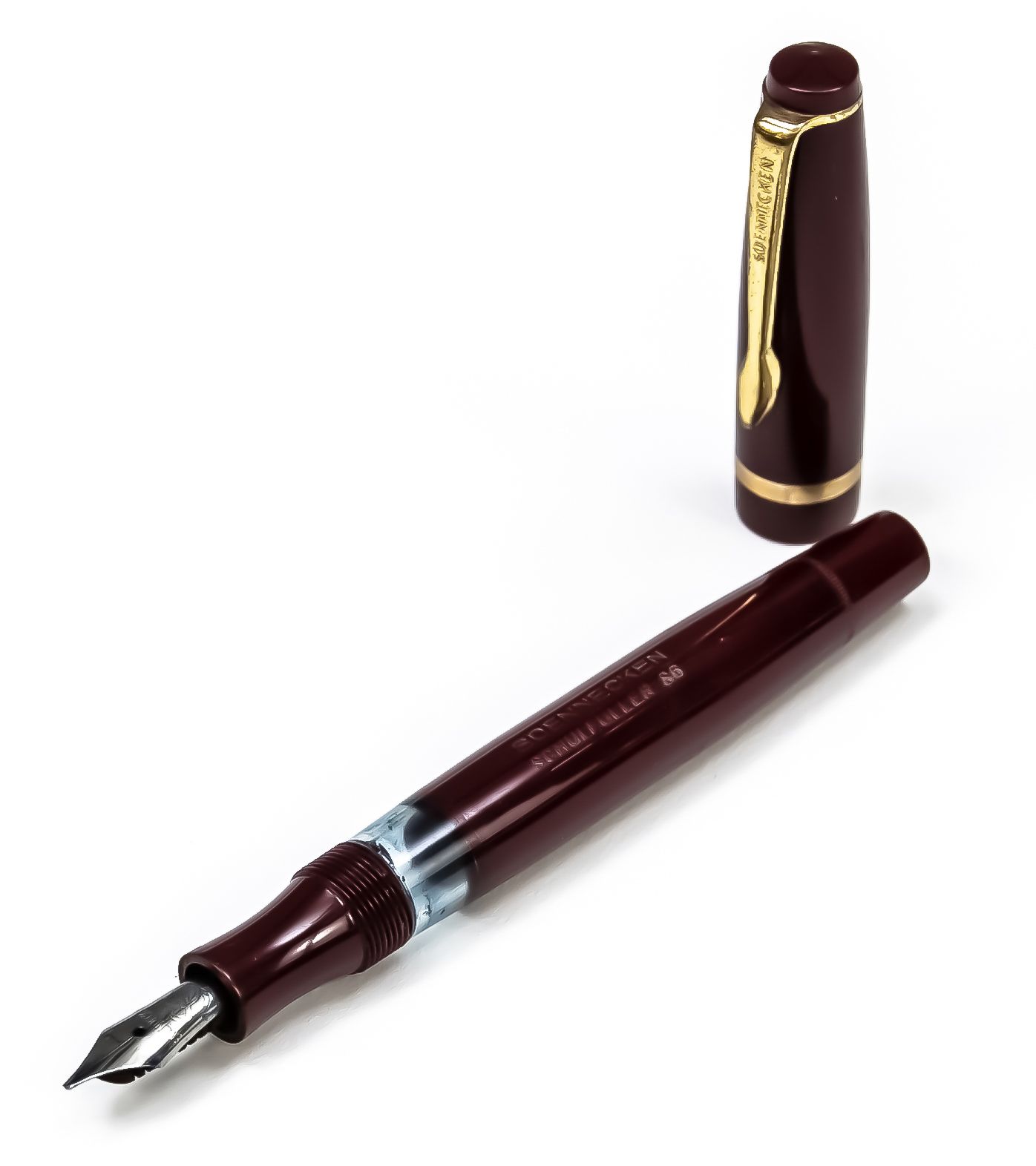 Null Soennecken活塞式钢笔，20世纪下半叶，钢笔尖，酒红色外壳，镀金应用，标有Schulfüller S6，笔帽有孔，长12厘米