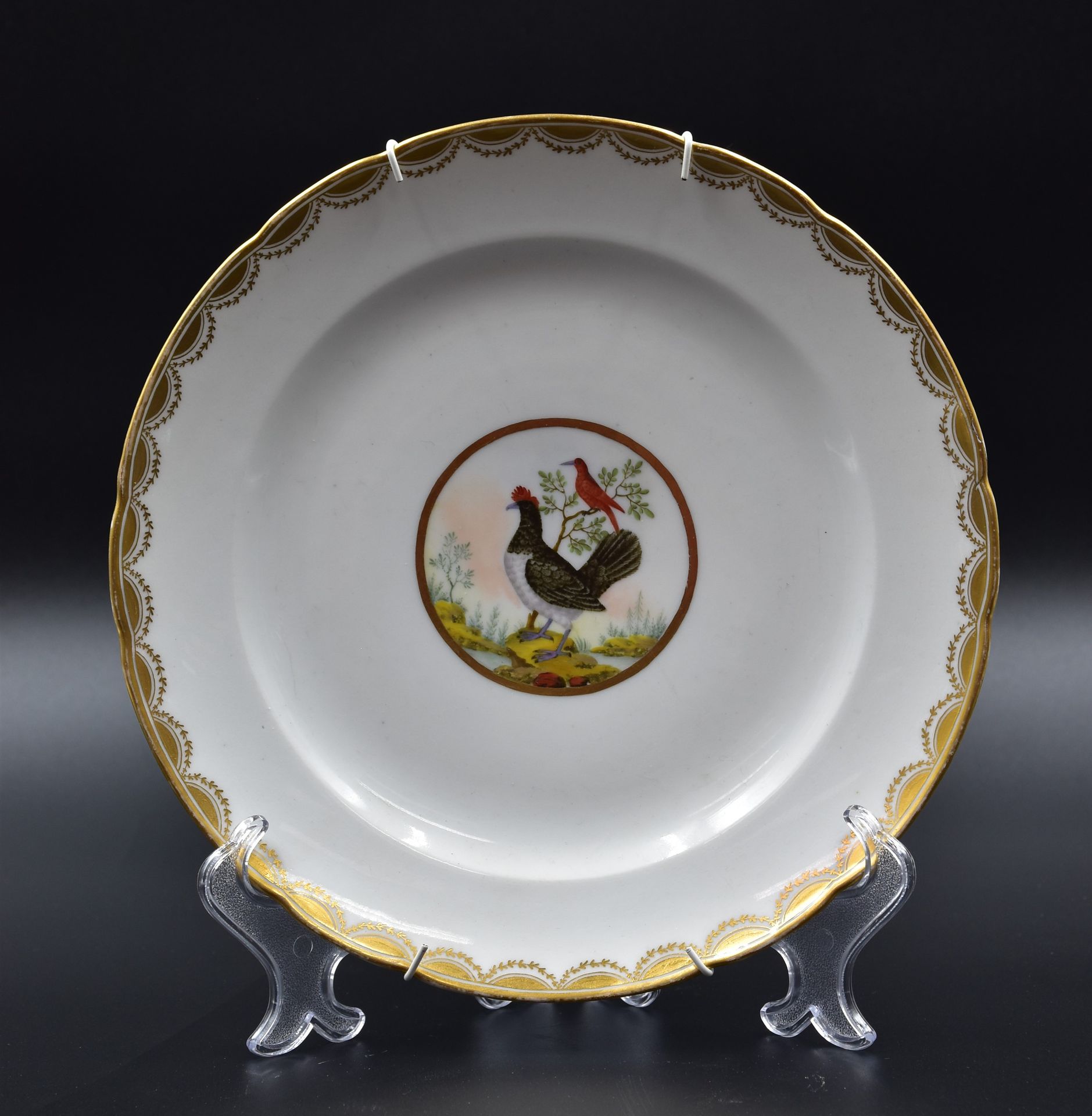 Null A late 18th century porcelain plate with polychrome decoration of birds.