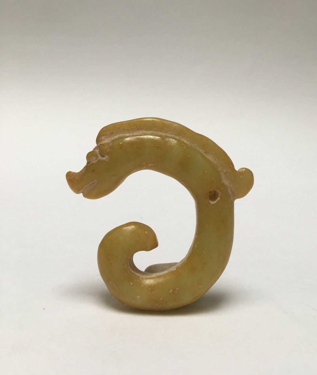 Null Dragon rolled up in jade "amber". A hole pierces the piece in the middle.

&hellip;