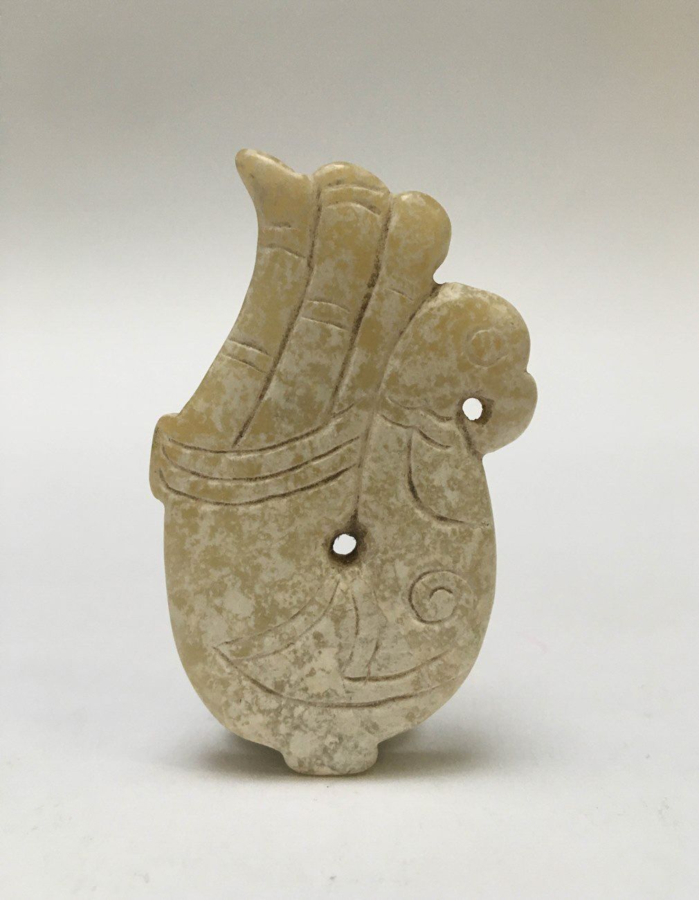 Null A fish-brain jade pendant representing a phoenix.

Han style.

H: 5cm