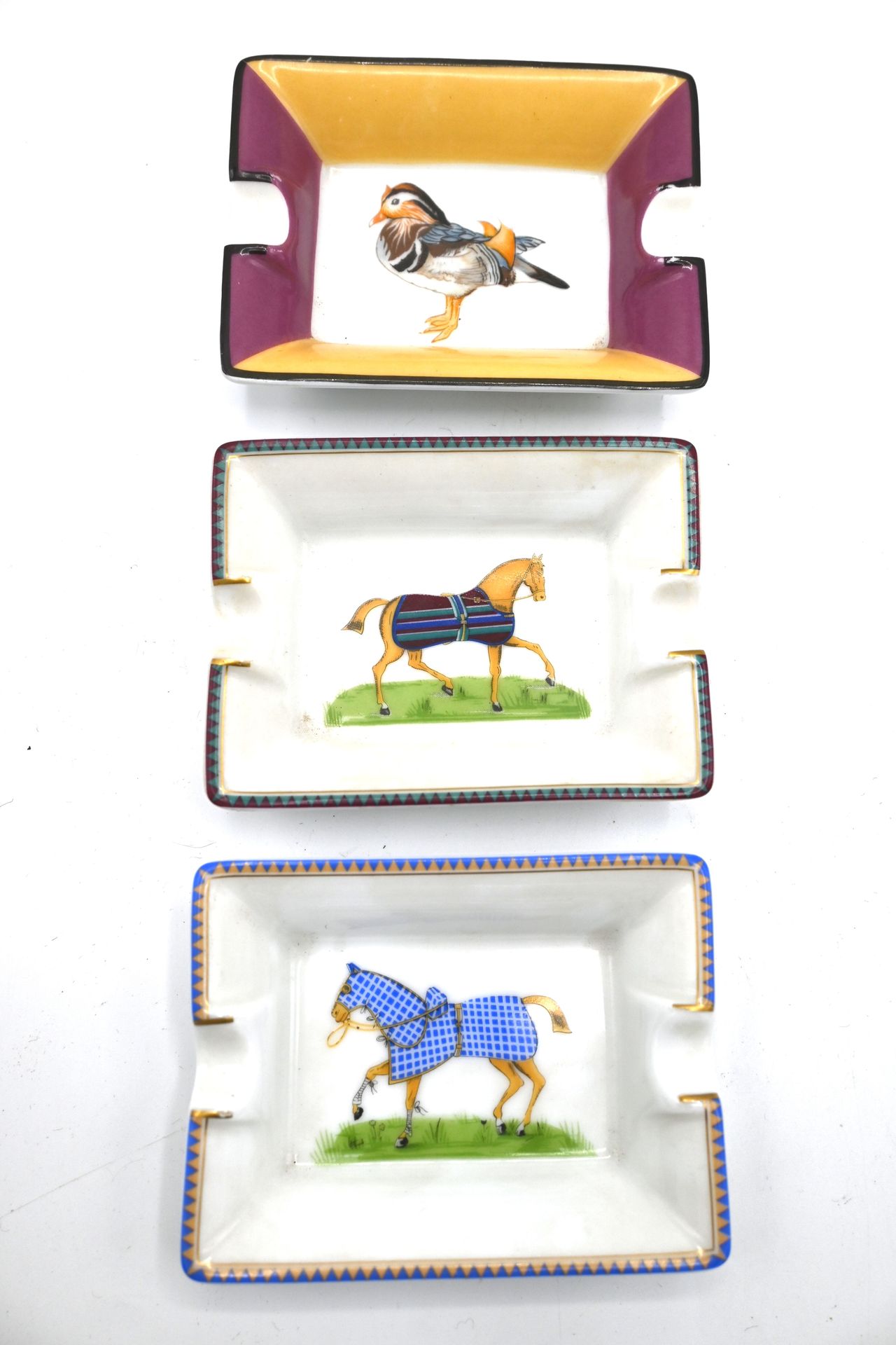 Null HERMES. Three porcelain ashtrays size S, two showing horses and one showing&hellip;
