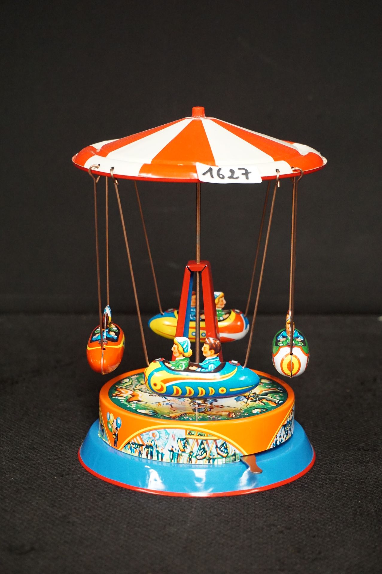 Null 
Turning merry-go-round toy - tin tuners - winding key - - H: 18 cm planes