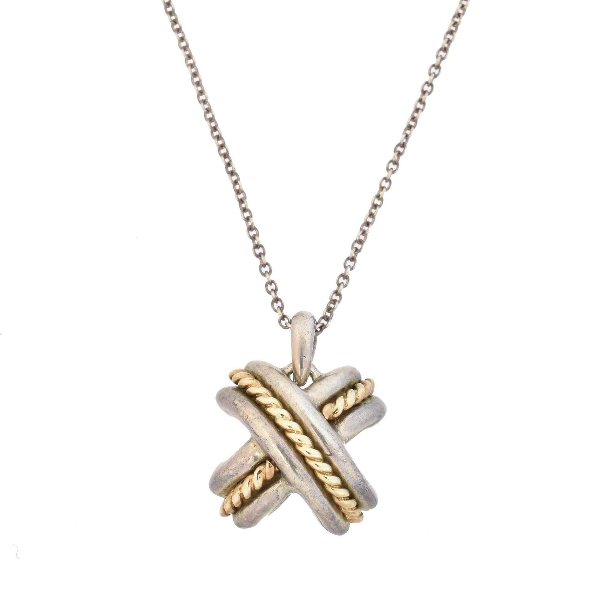 A Tiffany & Co. Silver and gold cross pendant, 
A Tiffany & Co. Silver and gold &hellip;
