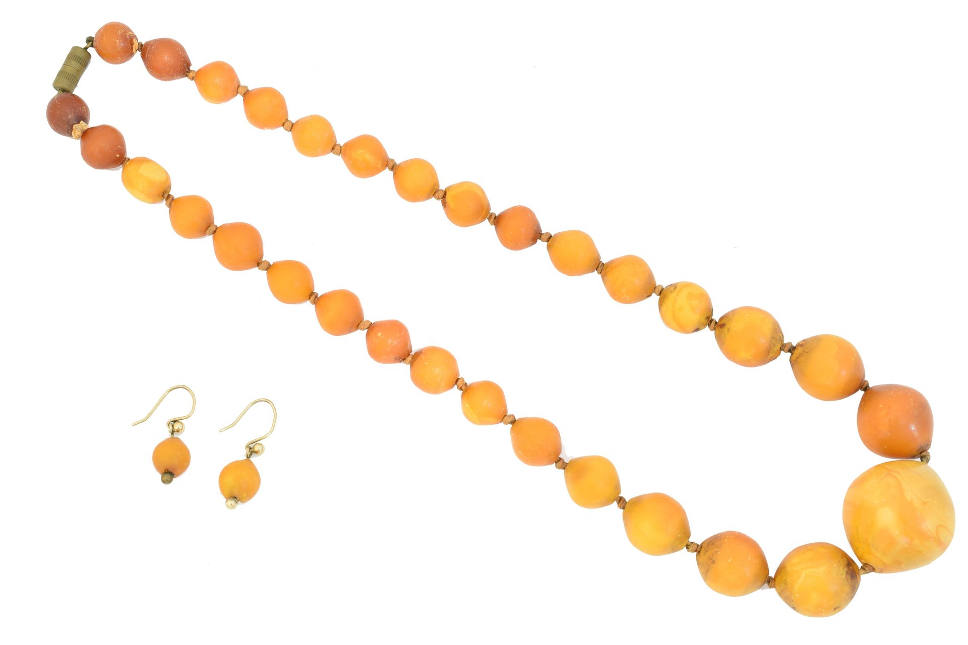 A butterscotch amber suite of jewellery, 
一套黄油琥珀首饰，包括一串有刻度的黄油琥珀珠子，以及一对落地耳环，长49厘米&hellip;