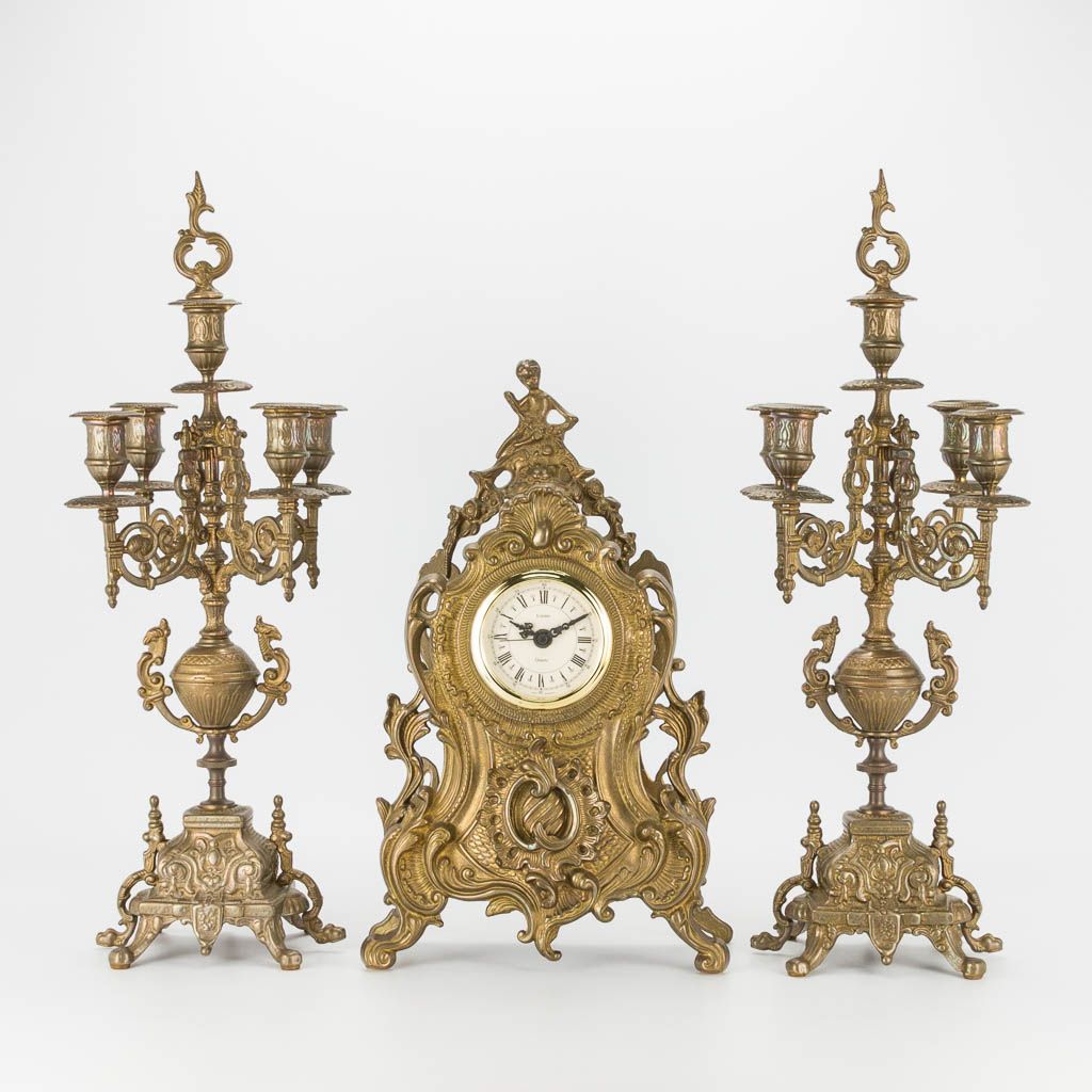 Null A bronze 3-piece garniture with clock and candelabra. The second half of th&hellip;
