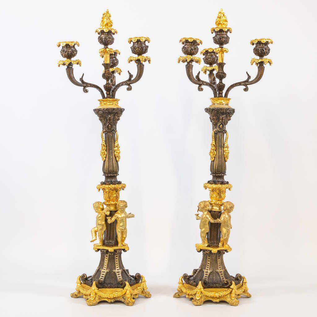 Null A pair of candelabra decorated with putti, combination of patinated and gil&hellip;