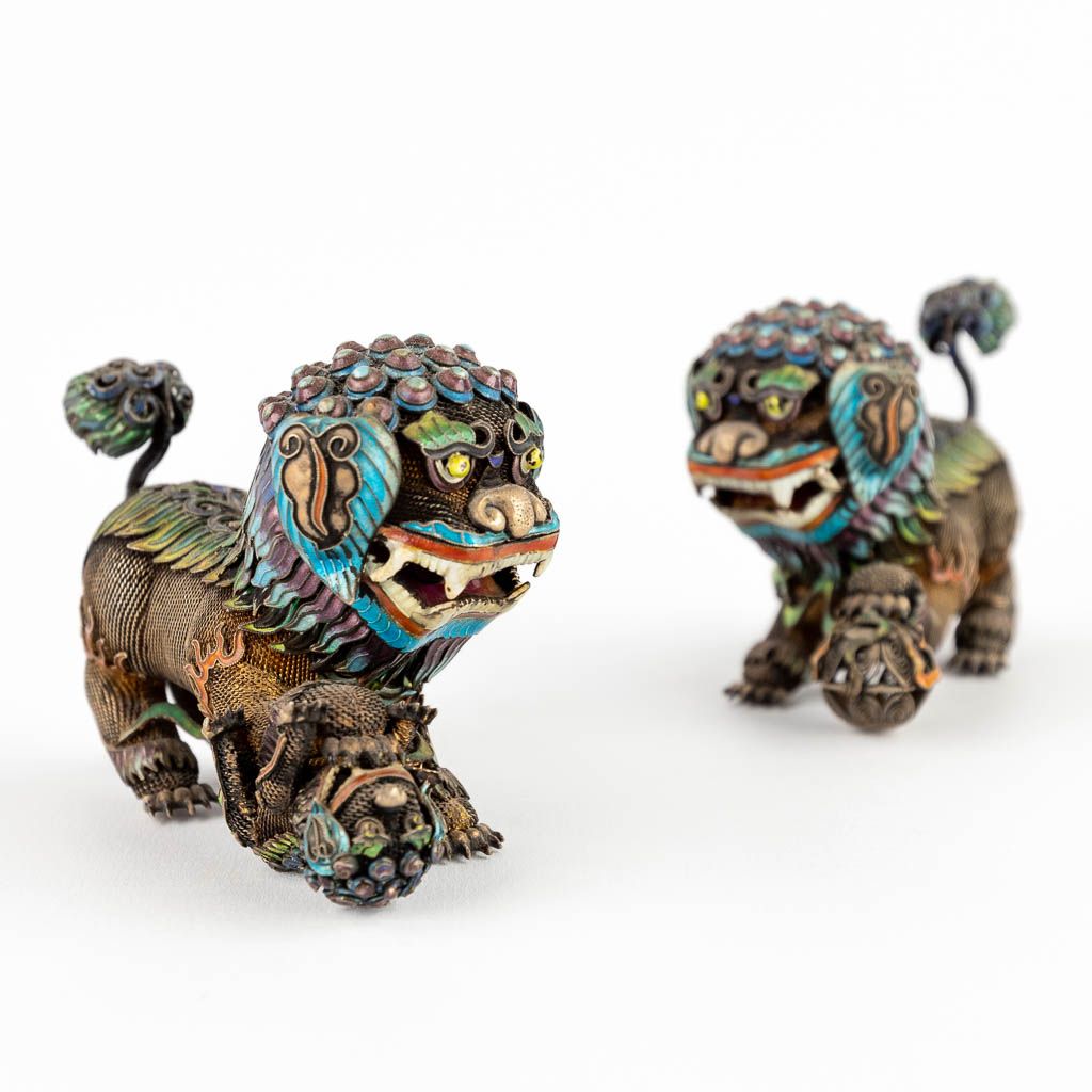 Null 
A pair of foo dogs, filigree silver finished with enamel.

20th century. 
&hellip;