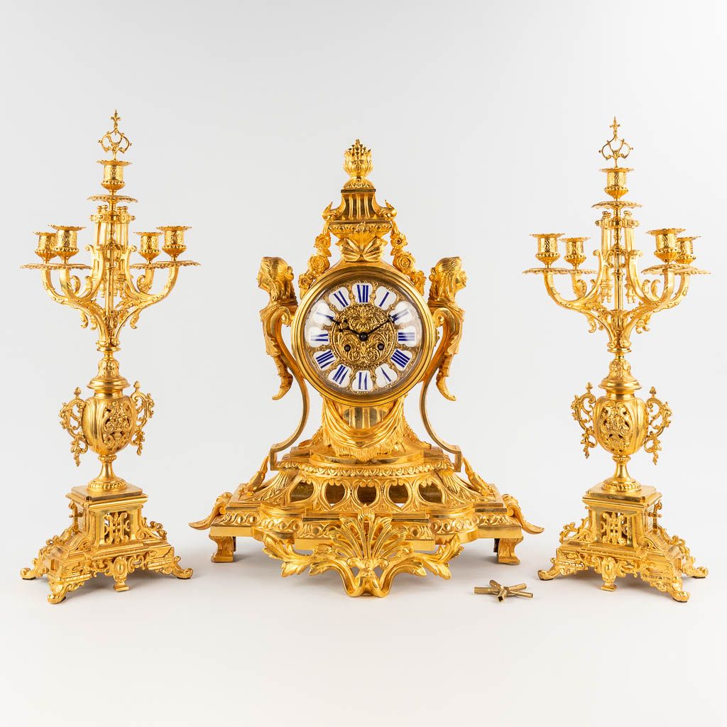 Null 
A three-piece mantle garniture clock and candelabra, gilt bronze in Louis &hellip;