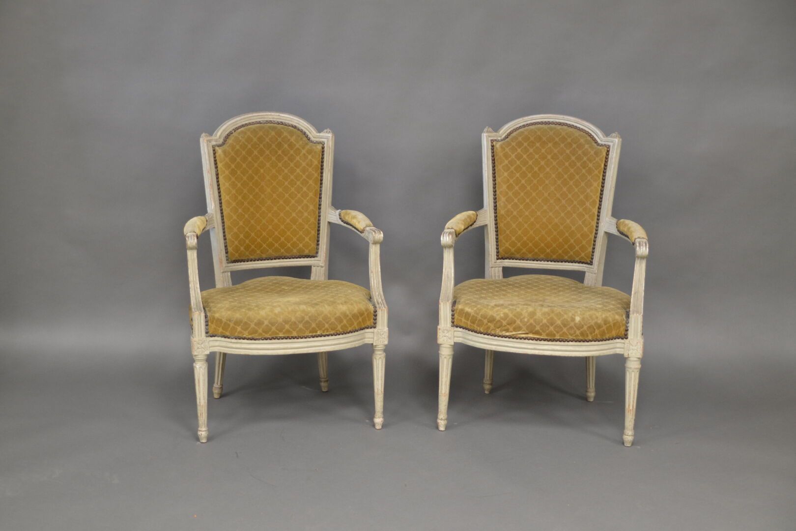 Null Pair of Louis XVI painted wood armchairs, gendarme hat backs, fluted and cu&hellip;