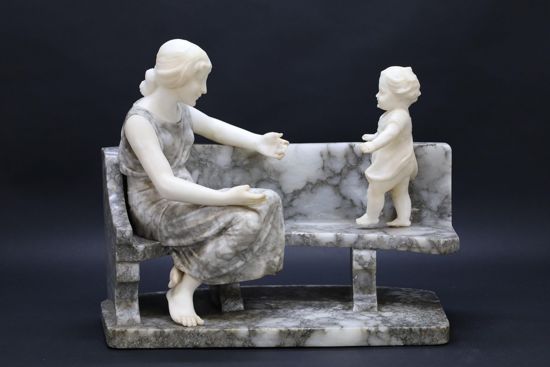 Null PUGI inscribed. 'Mother with child on couch' hand-sculpted two-tone alabast&hellip;