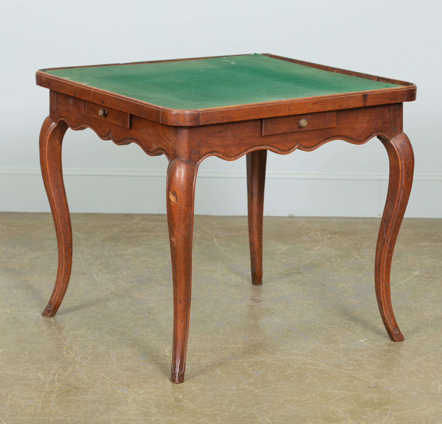 Null 胡桃木雕刻的游戏桌，腰部有四个抽屉。 
腰部有起伏的装饰。 
它站在四个弯曲的腿上。
路易十五时期。
绿色的毡顶。
高_68,6厘米，宽_75,6厘米&hellip;