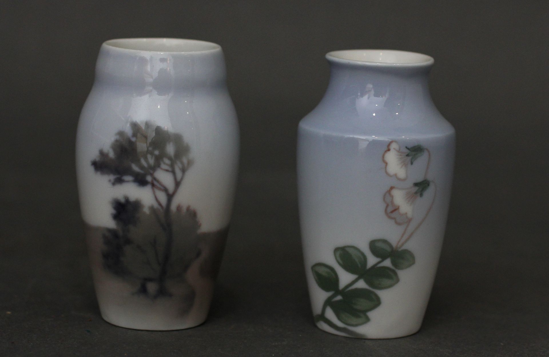Null 宾-格朗德哈尔

两个浅蓝色背景的花和树的小瓷器柱形花瓶，签名

高：7厘米。