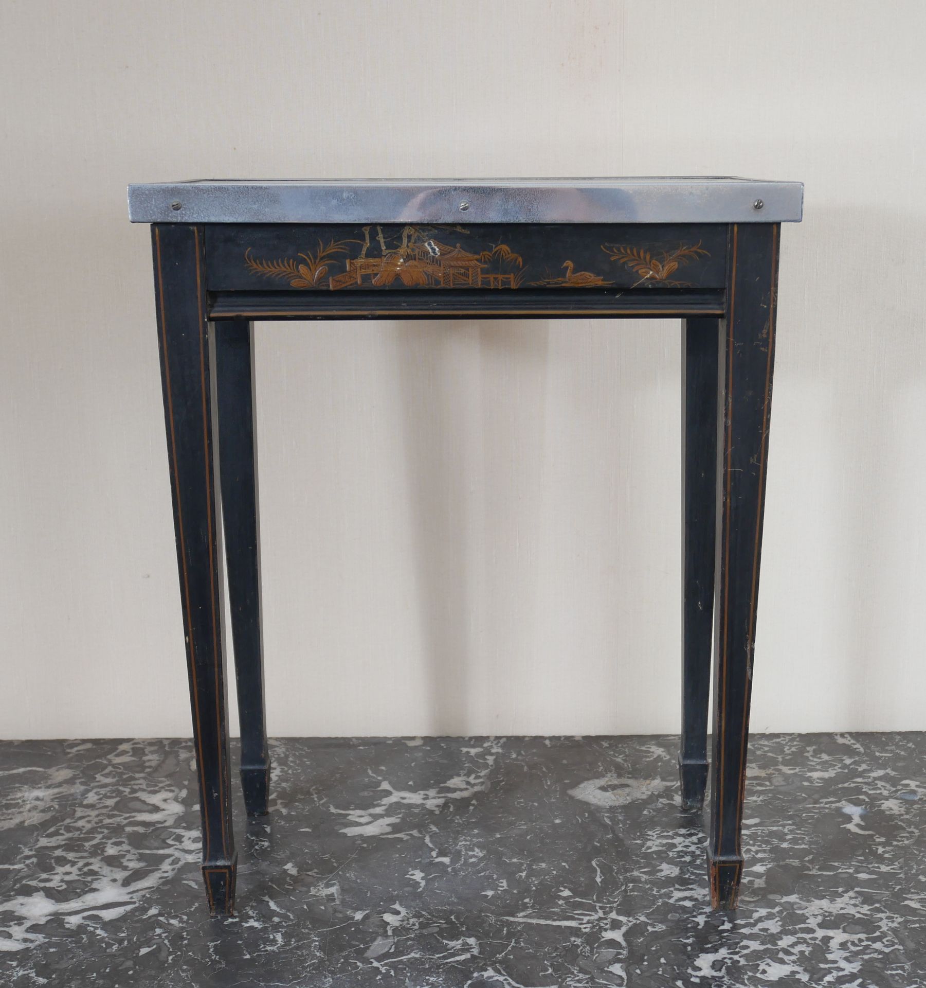 Null 
长方形黑漆木制镀金风景装饰基座桌，中国




高：49，宽：40.5，深：25.5厘米（损坏的玻璃桌面由一个螺丝固定的金属框架固定，丢失）。