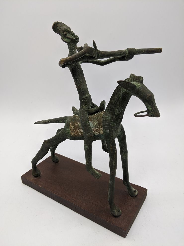 Null A West African tribal bronze of a horseback rider firing a musket, Dogon or&hellip;