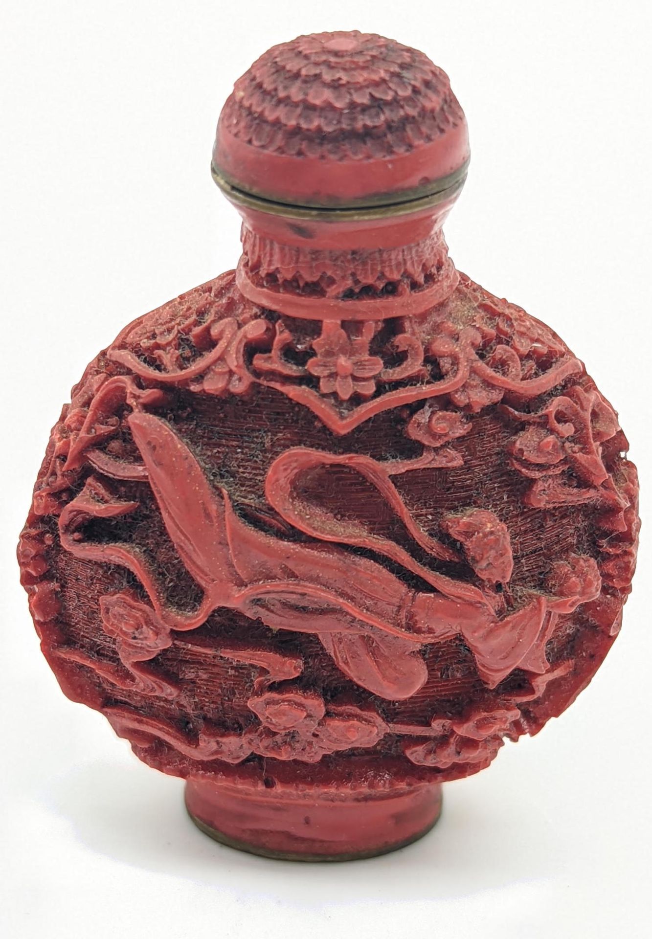 Null A Chinese red lacquered snuff bottle, carved designs depicting a flying mai&hellip;