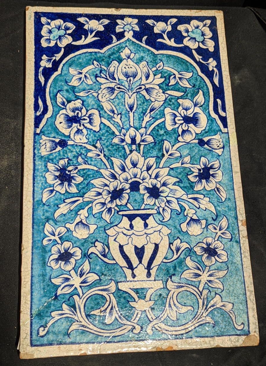 Null A large 19th century Indian Multan tile with floral designs, 42cm x 25.5cm