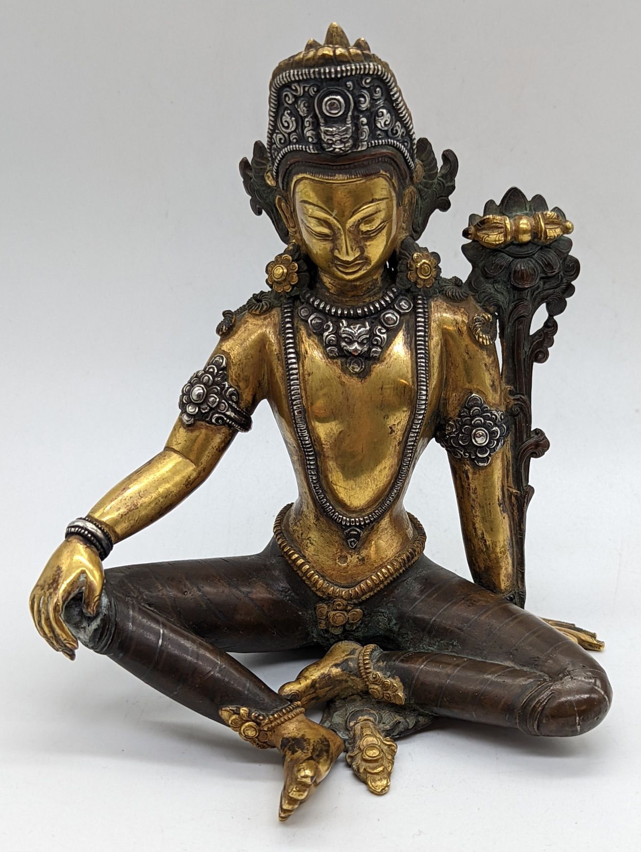 Null A Nepalese seated Deity Indra figure in gilded bronze and applied silver, N&hellip;