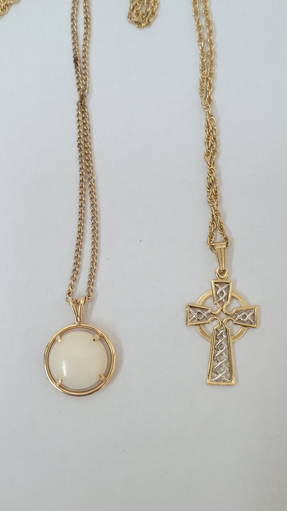 TWO GOLD COLOURED NECKLACES, (i) with a cross pendant (ii) with a round stone pe&hellip;