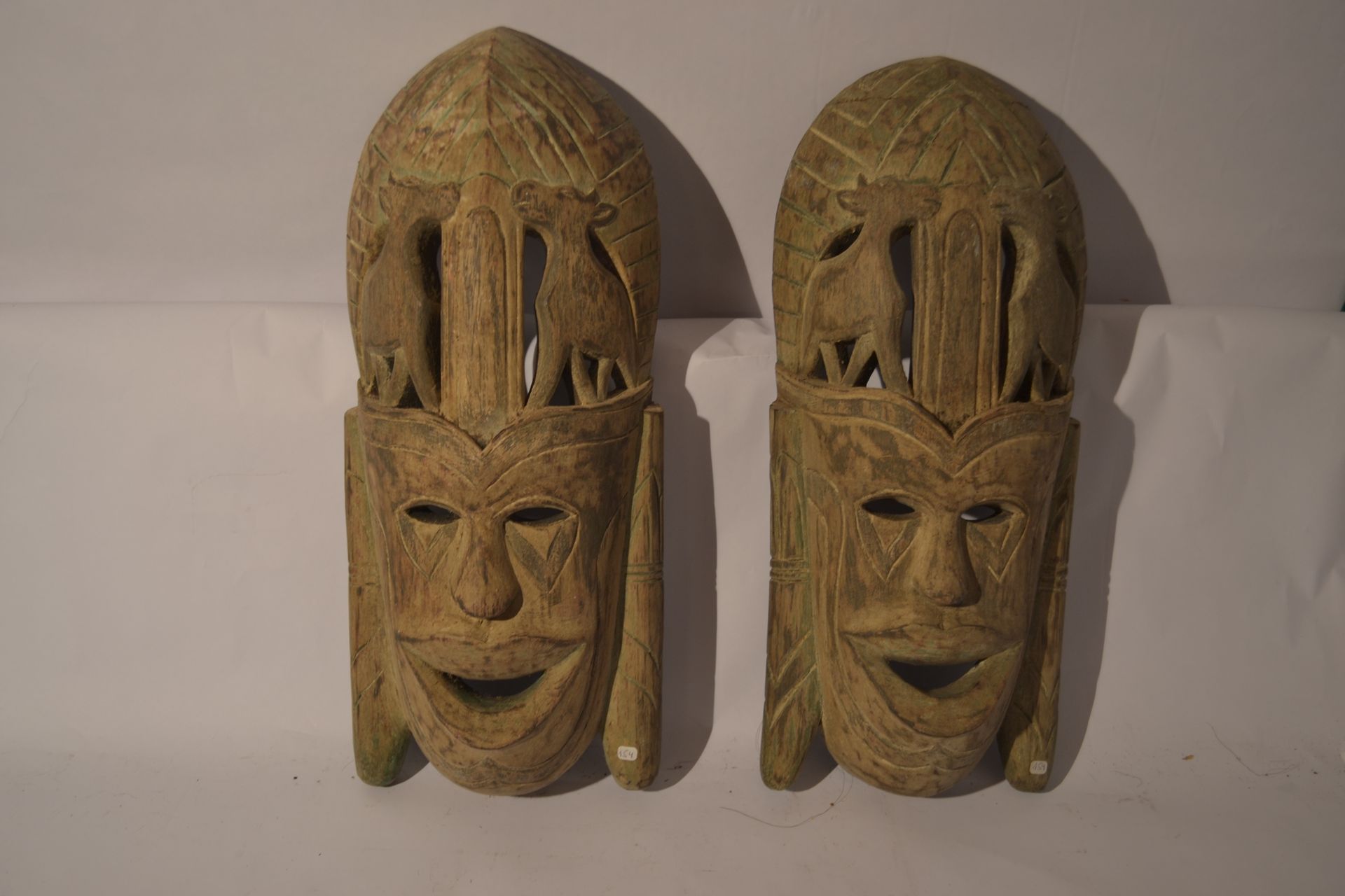 Null 一对具有米色和绿色铜锈的原始面具

淡淡的异国情调的木材。

 50 x 22 x 9

重量：2,5公斤。