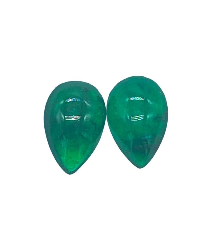 Null Two emerald cabochons on paper, pear size, total approx. 10 cts