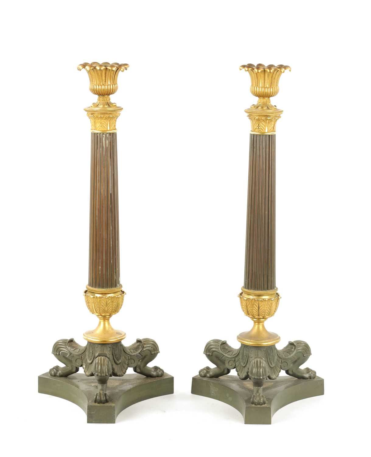 A PAIR OF REGENCY BRONZE AND ORMOLU CANDLESTICKS WITH LATER OIL LAMP FITTINGS EI&hellip;